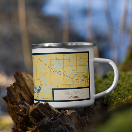 Right View Custom Tri-Lakes Indiana Map Enamel Mug in Woodblock on Grass With Trees in Background