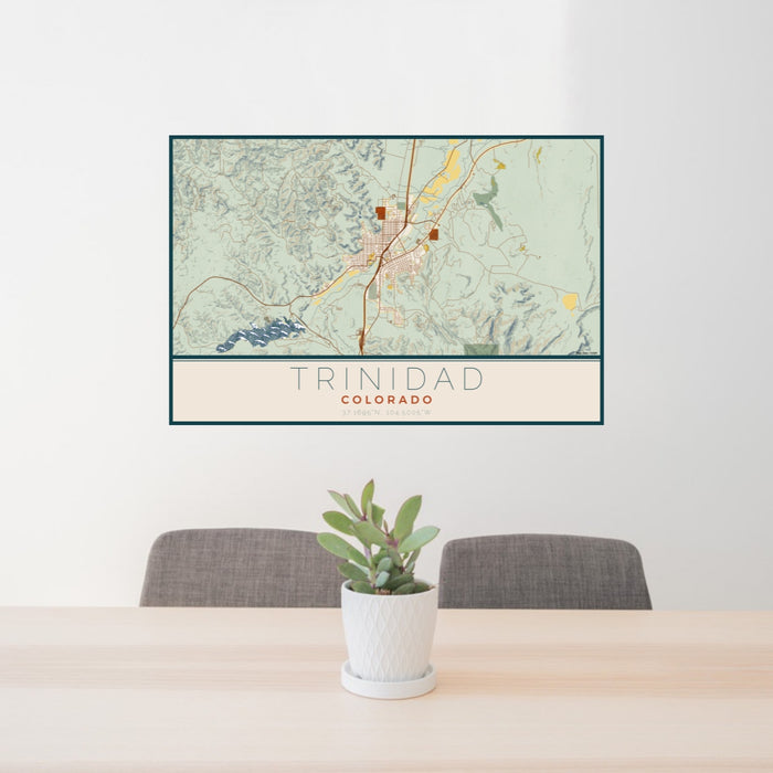 24x36 Trinidad Colorado Map Print Lanscape Orientation in Woodblock Style Behind 2 Chairs Table and Potted Plant