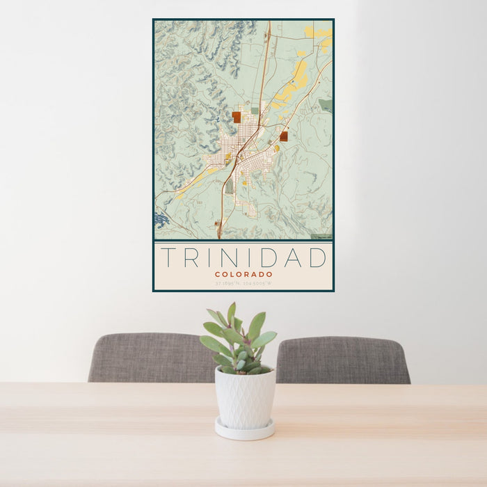 24x36 Trinidad Colorado Map Print Portrait Orientation in Woodblock Style Behind 2 Chairs Table and Potted Plant