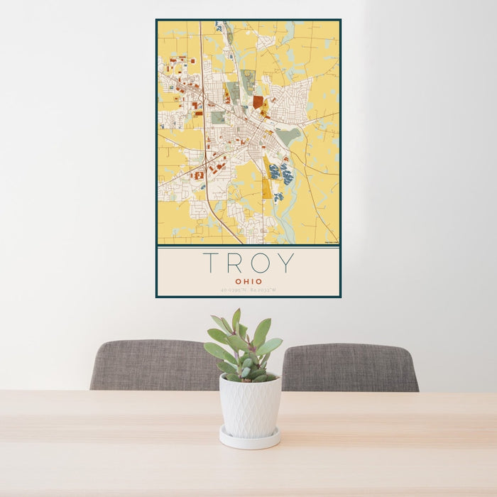 24x36 Troy Ohio Map Print Portrait Orientation in Woodblock Style Behind 2 Chairs Table and Potted Plant