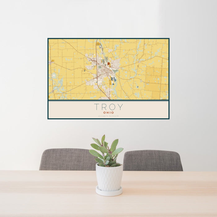 24x36 Troy Ohio Map Print Landscape Orientation in Woodblock Style Behind 2 Chairs Table and Potted Plant