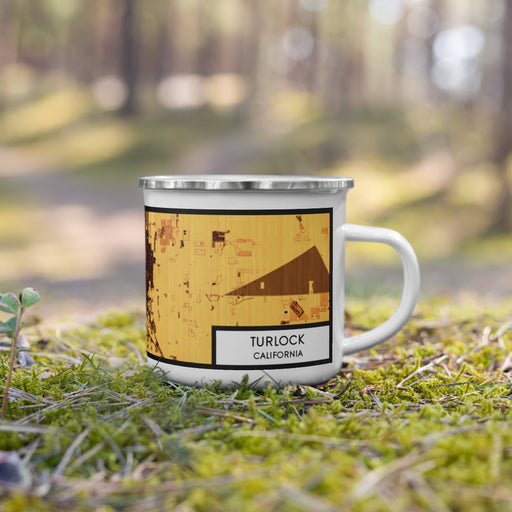 Right View Custom Turlock California Map Enamel Mug in Ember on Grass With Trees in Background