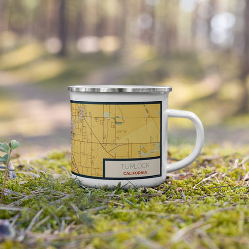 Right View Custom Turlock California Map Enamel Mug in Woodblock on Grass With Trees in Background
