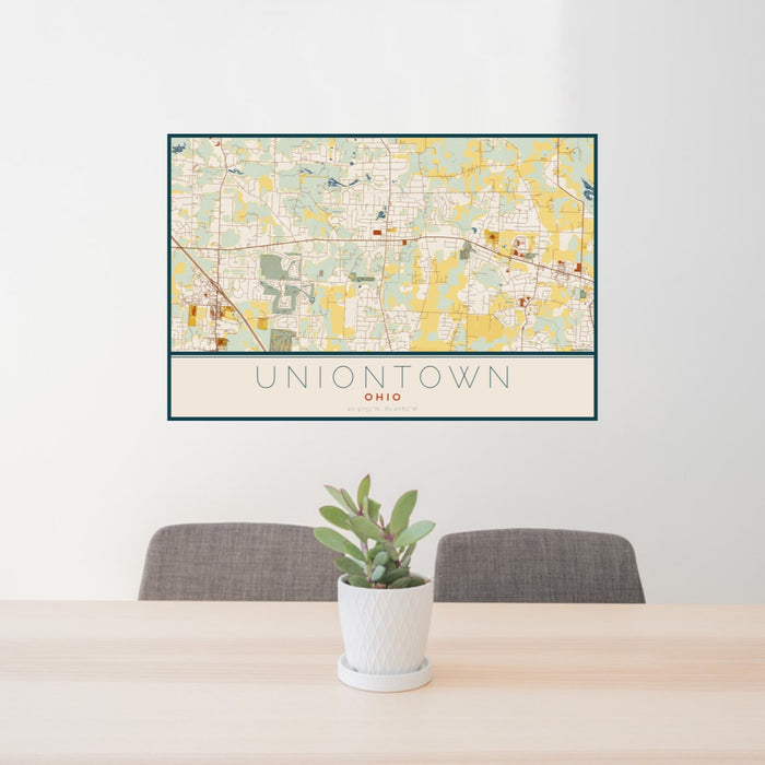 24x36 Uniontown Ohio Map Print Landscape Orientation in Woodblock Style Behind 2 Chairs Table and Potted Plant