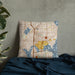 Custom University District Seattle Map Throw Pillow in Woodblock on Bedding Against Wall