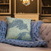 Custom Upper Peninsula Michigan Map Throw Pillow in Woodblock on Cream Colored Couch