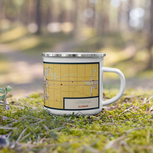 Right View Custom Urbana Illinois Map Enamel Mug in Woodblock on Grass With Trees in Background
