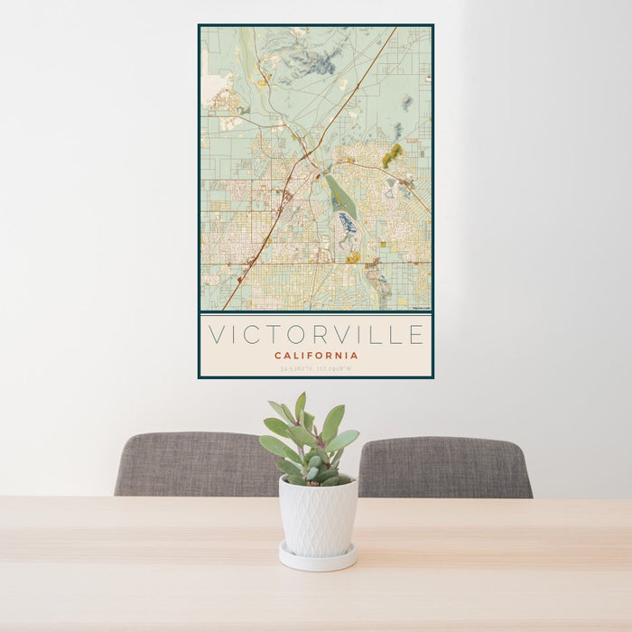 24x36 Victorville California Map Print Portrait Orientation in Woodblock Style Behind 2 Chairs Table and Potted Plant