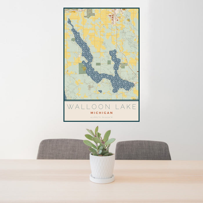 24x36 Walloon Lake Michigan Map Print Portrait Orientation in Woodblock Style Behind 2 Chairs Table and Potted Plant