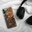 Custom Warsaw Missouri Map Phone Case in Ember on Table with Black Headphones