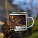 Right View Custom West Lafayette Indiana Map Enamel Mug in Ember on Grass With Trees in Background