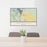 24x36 Whitefish Montana Map Print Lanscape Orientation in Woodblock Style Behind 2 Chairs Table and Potted Plant