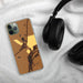 Custom Wilson Arkansas Map Phone Case in Ember on Table with Black Headphones