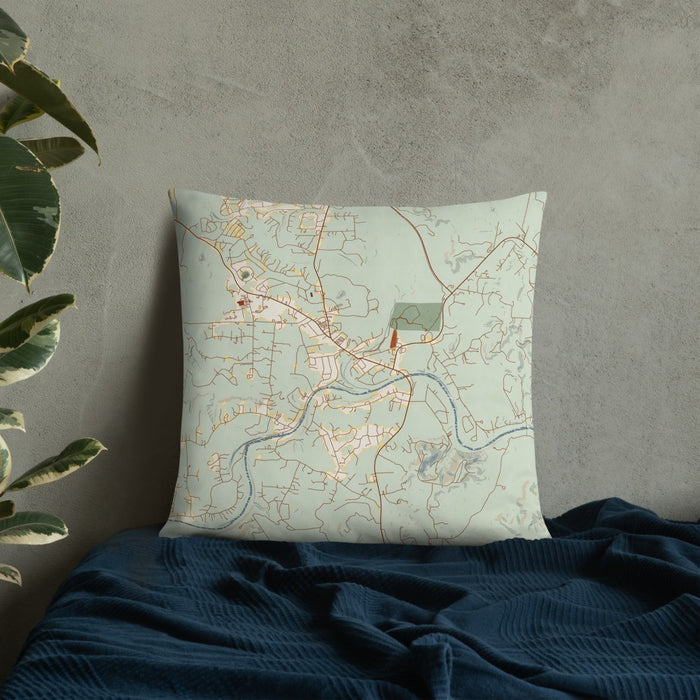 Custom Wimberley Texas Map Throw Pillow in Woodblock on Bedding Against Wall