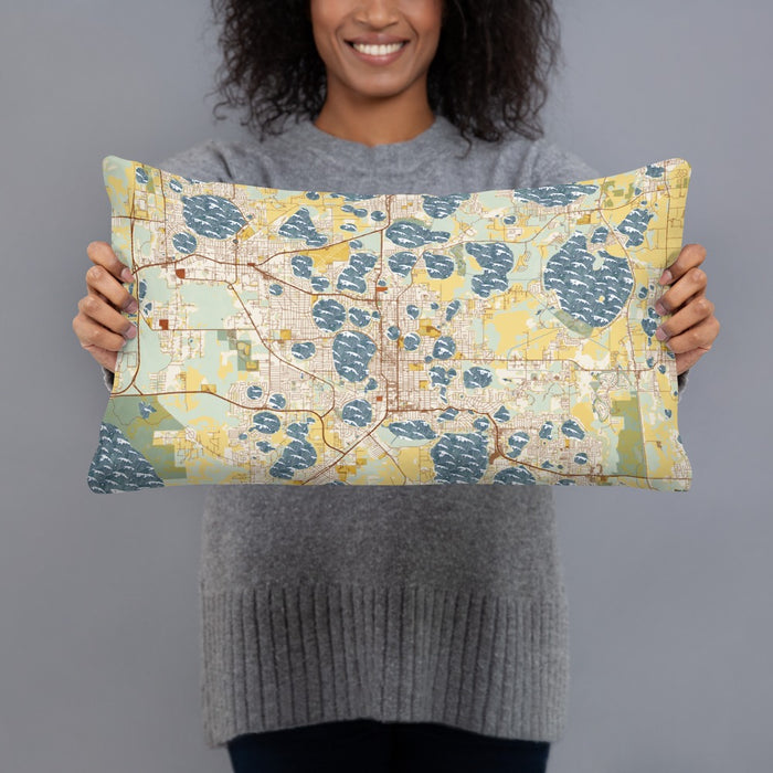 Person holding 20x12 Custom Winter Haven Florida Map Throw Pillow in Woodblock