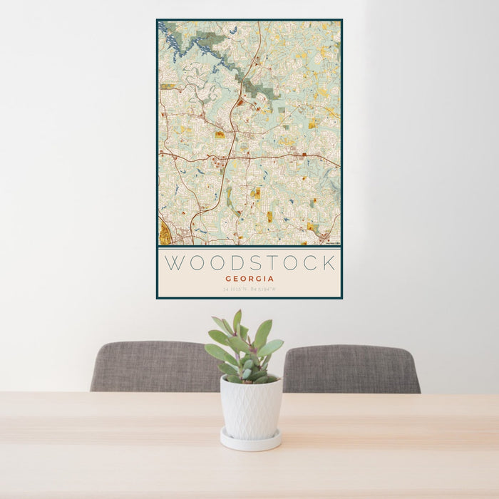 24x36 Woodstock Georgia Map Print Portrait Orientation in Woodblock Style Behind 2 Chairs Table and Potted Plant