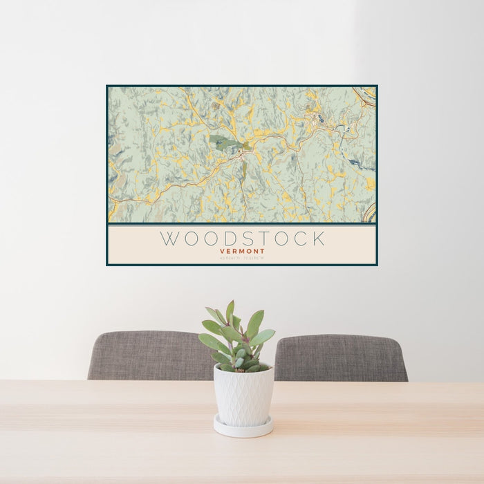 24x36 Woodstock Vermont Map Print Landscape Orientation in Woodblock Style Behind 2 Chairs Table and Potted Plant
