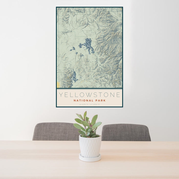 24x36 Yellowstone National Park Map Print Portrait Orientation in Woodblock Style Behind 2 Chairs Table and Potted Plant