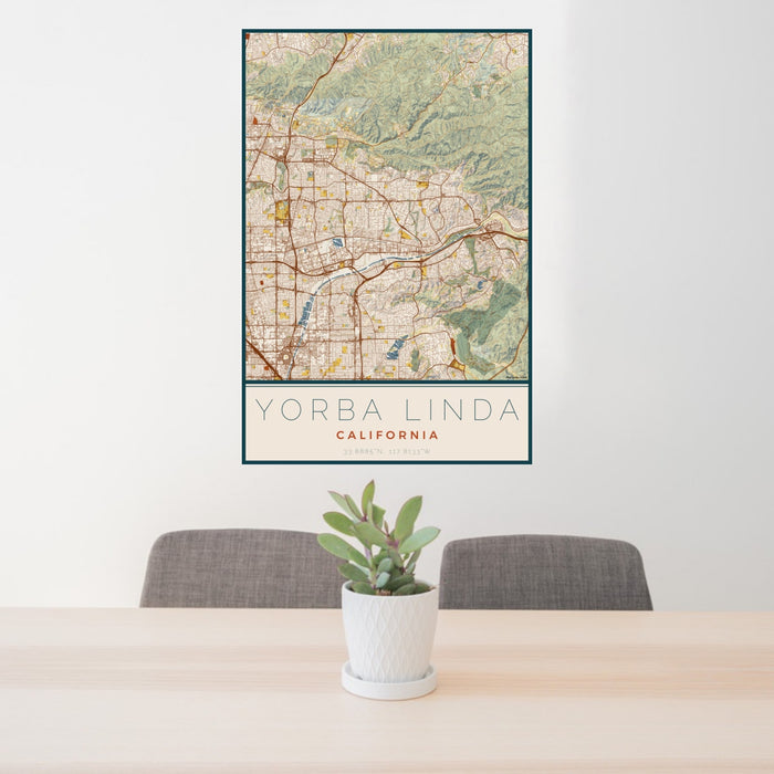 24x36 Yorba Linda California Map Print Portrait Orientation in Woodblock Style Behind 2 Chairs Table and Potted Plant