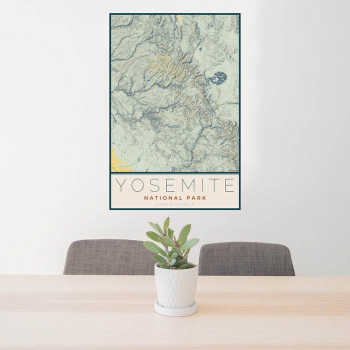 24x36 Yosemite National Park Map Print Portrait Orientation in Woodblock Style Behind 2 Chairs Table and Potted Plant