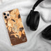 Custom Zion National Park Map Phone Case in Ember on Table with Black Headphones